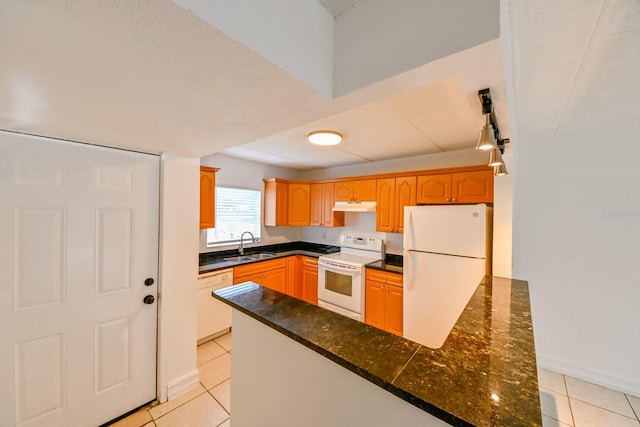 kitchen with sink, light tile patterned floors, white appliances, and kitchen peninsula