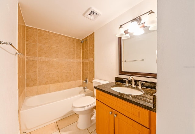 full bathroom featuring tiled shower / bath, tile patterned floors, toilet, and vanity