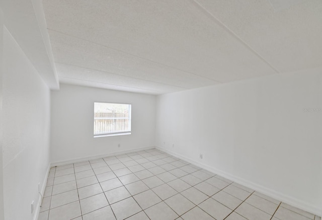 unfurnished room featuring light tile patterned floors