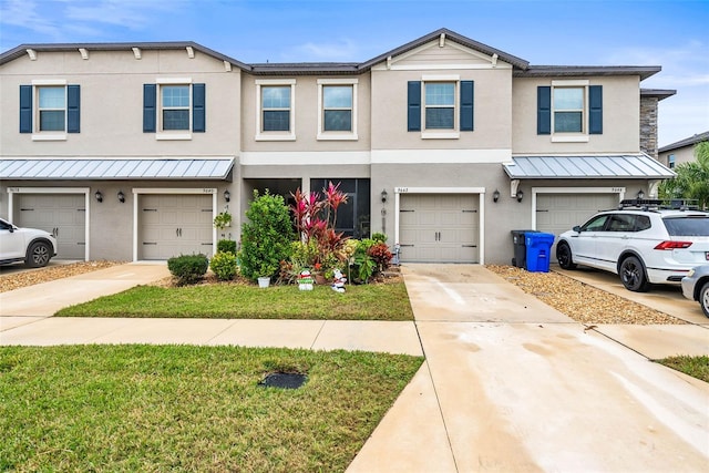 townhome / multi-family property with a garage and a front lawn