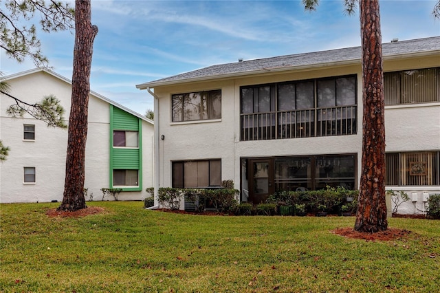 rear view of property with a lawn