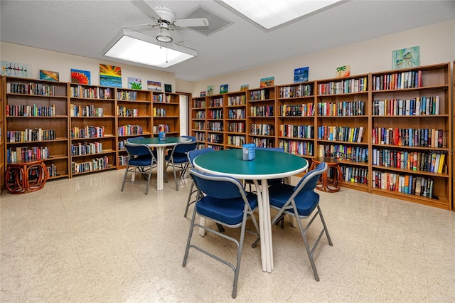 interior space with ceiling fan