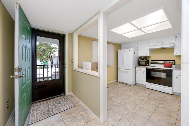 kitchen with white cabinets, light tile patterned flooring, white refrigerator, and electric range