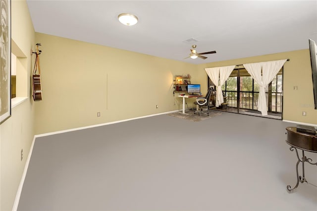 interior space featuring ceiling fan and concrete floors