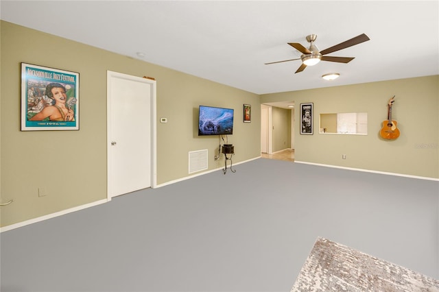 unfurnished living room with carpet and ceiling fan