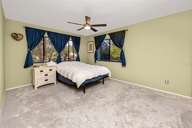 bedroom featuring light colored carpet and ceiling fan