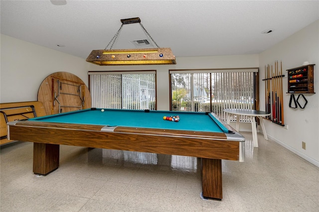 game room with a textured ceiling