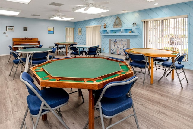 playroom with ceiling fan and light hardwood / wood-style flooring