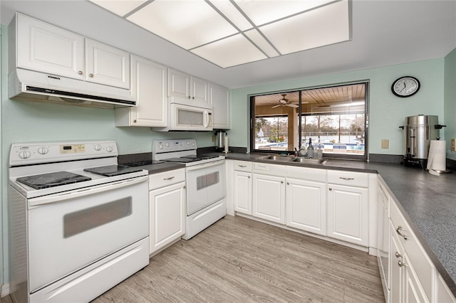 kitchen with sink, white appliances, and white cabinetry