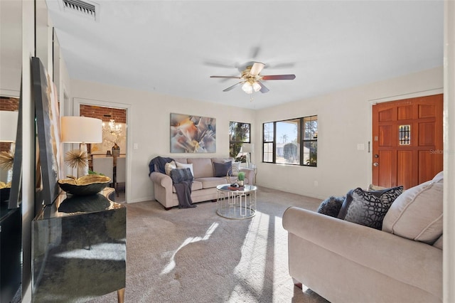 carpeted living room with ceiling fan