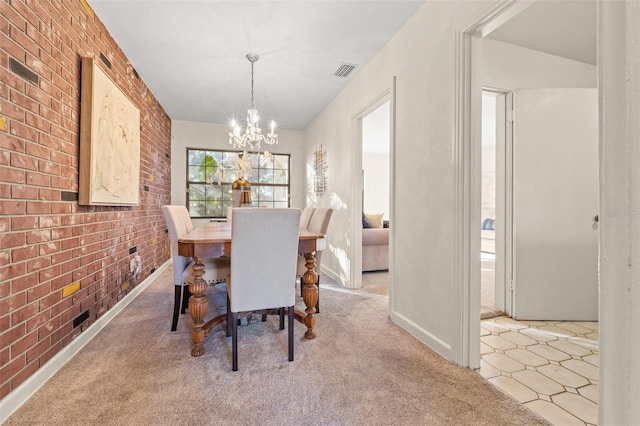 dining area featuring brick wall, a chandelier, and light carpet