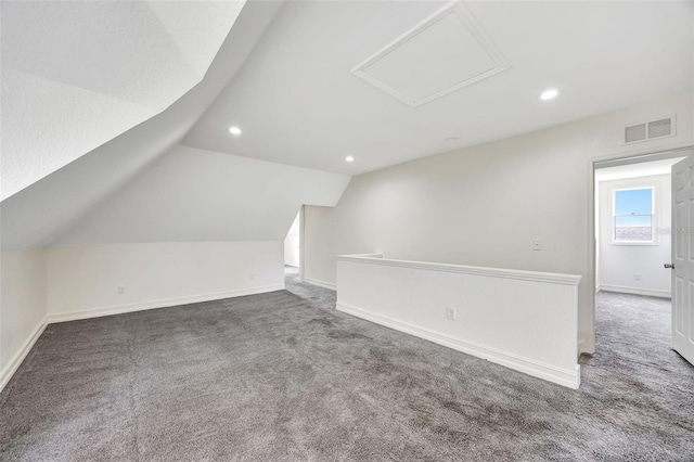 bonus room featuring vaulted ceiling and carpet