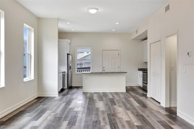 kitchen featuring stainless steel appliances, a healthy amount of sunlight, and white cabinets