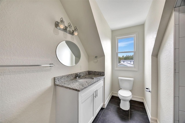 bathroom with vanity, toilet, and tile patterned flooring