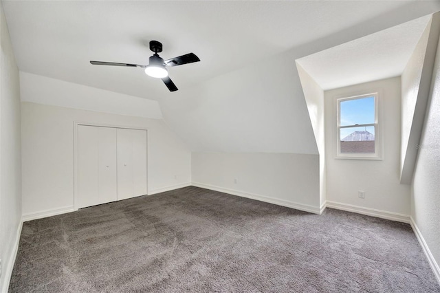 additional living space featuring vaulted ceiling, ceiling fan, and dark carpet