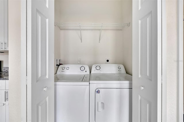 clothes washing area with washer and dryer