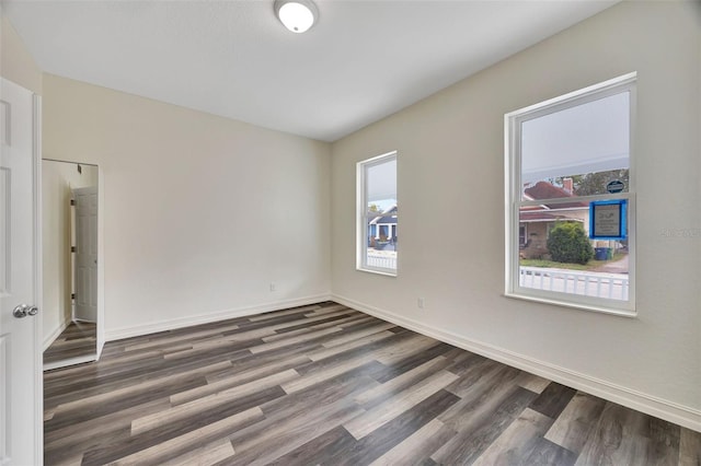 empty room with dark wood-type flooring