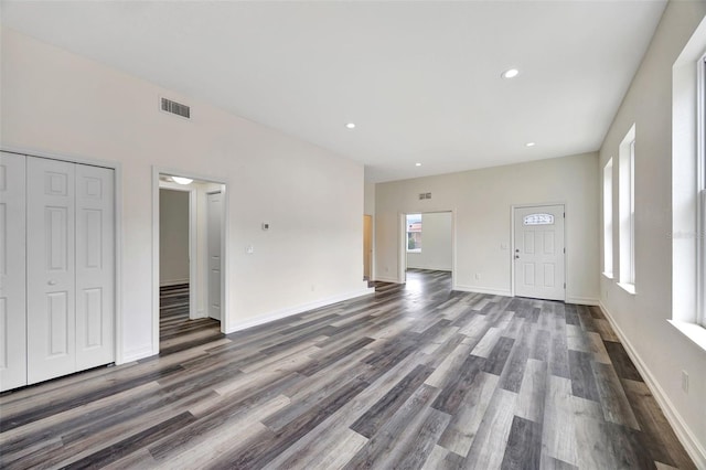 unfurnished living room with dark hardwood / wood-style floors