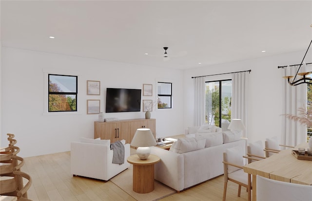 living room featuring ceiling fan and light wood-type flooring