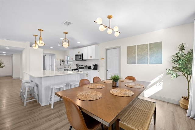 dining room with light hardwood / wood-style floors