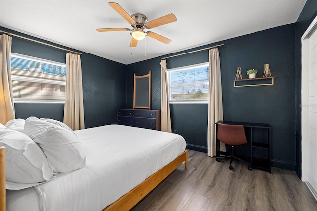 bedroom featuring hardwood / wood-style floors and ceiling fan