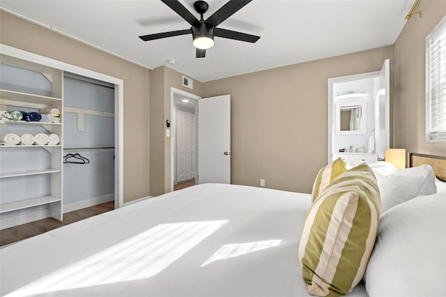 bedroom with a closet, dark hardwood / wood-style floors, and ceiling fan