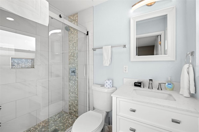 bathroom with vanity, an enclosed shower, and toilet