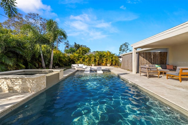 view of swimming pool with an in ground hot tub, outdoor lounge area, and a patio