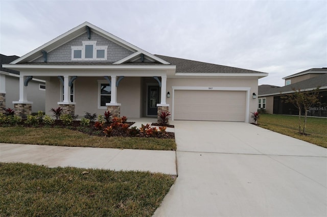 view of front of home featuring a porch, a garage, and a front yard