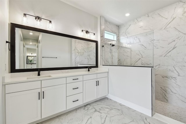 bathroom featuring tiled shower and vanity