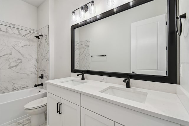 full bathroom with tiled shower / bath, vanity, and toilet