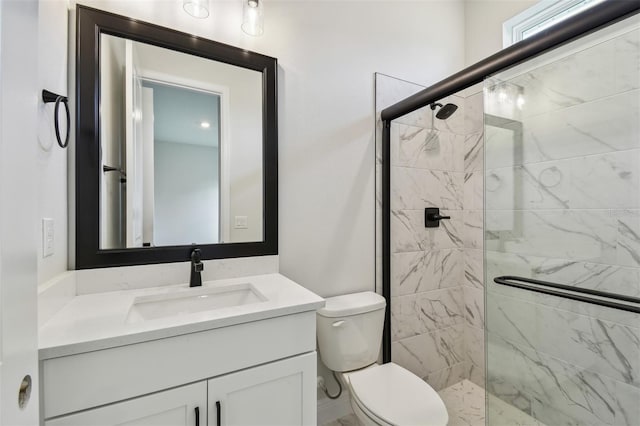 bathroom featuring vanity, toilet, and a shower with shower door