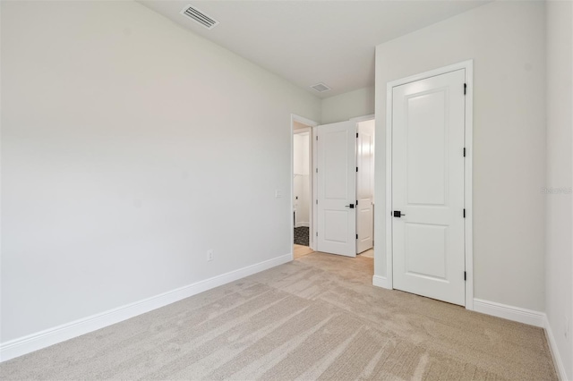 unfurnished bedroom with light carpet