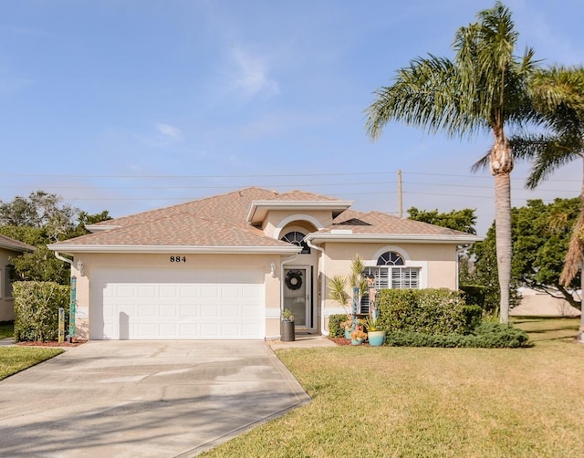 view of front of home featuring a garage and a front yard