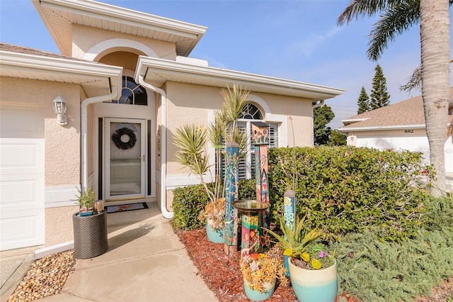 view of exterior entry featuring a garage