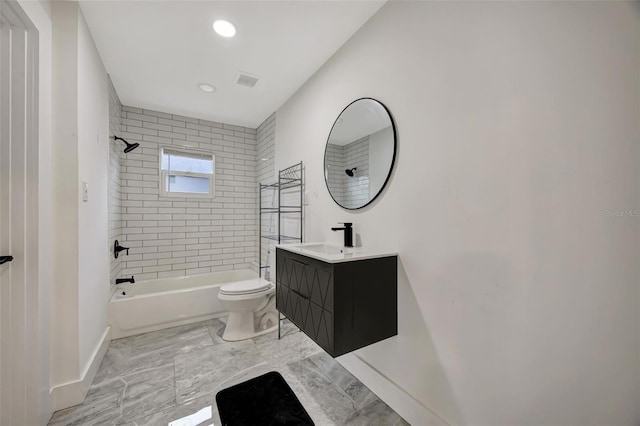 full bathroom featuring vanity, tiled shower / bath, and toilet