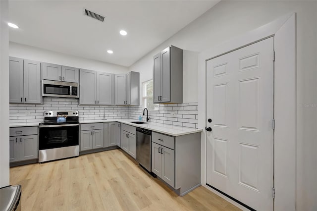 kitchen with stainless steel appliances and gray cabinetry