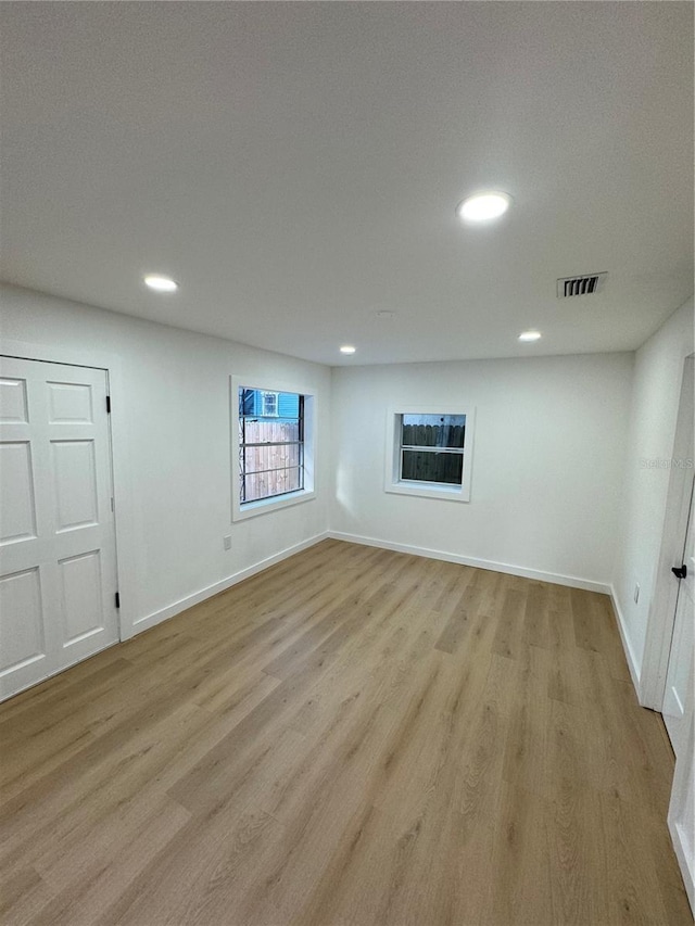 basement with light hardwood / wood-style flooring