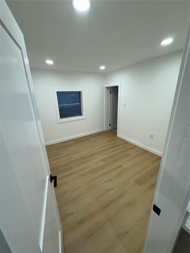 unfurnished room with light wood-type flooring