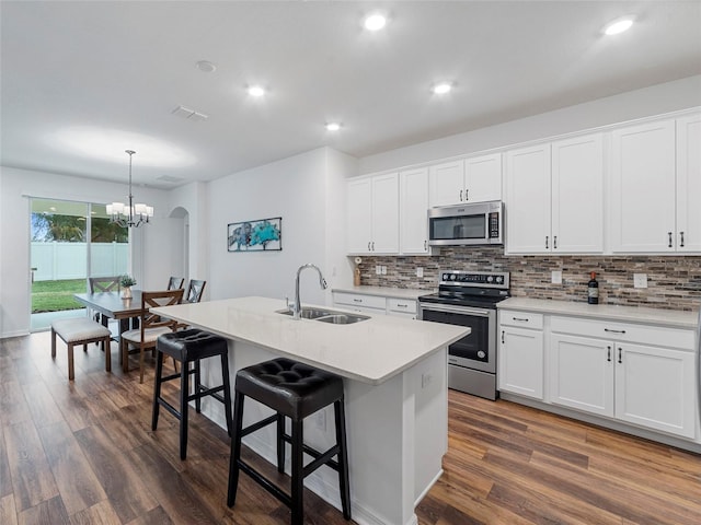 kitchen with sink, white cabinets, and stainless steel appliances