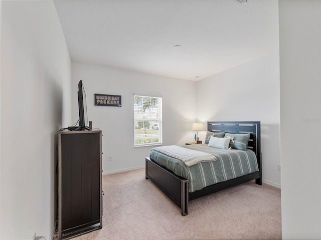 bedroom featuring light carpet