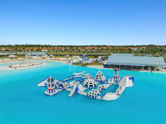 bird's eye view featuring a water view and a beach view