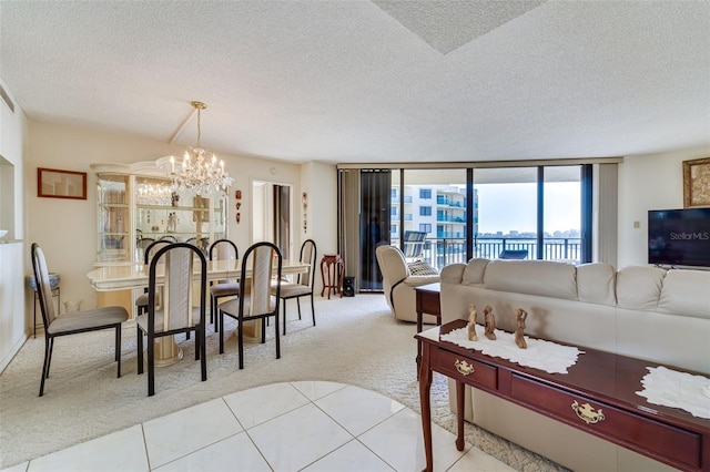 dining space with a textured ceiling, an inviting chandelier, light tile patterned flooring, and light colored carpet