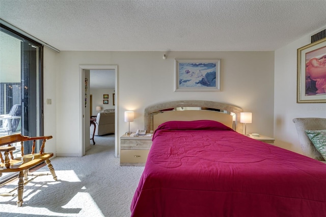 carpeted bedroom featuring a textured ceiling