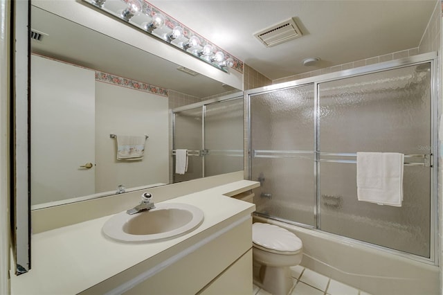 full bath with toilet, bath / shower combo with glass door, vanity, and visible vents