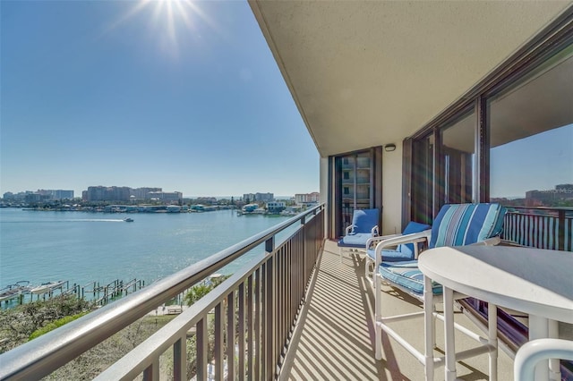 balcony featuring a view of city and a water view