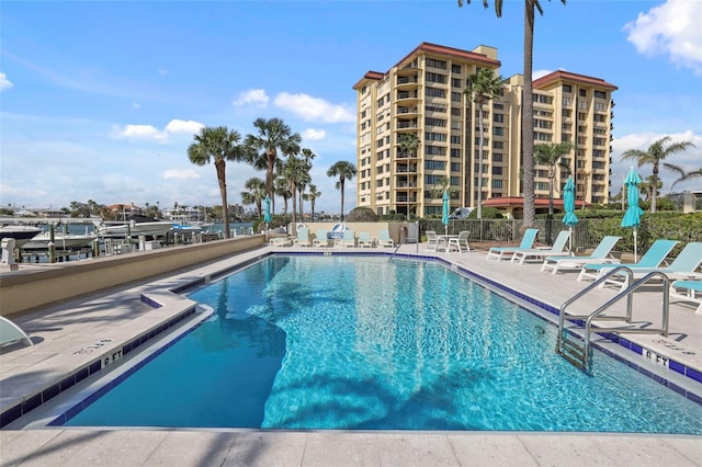 pool featuring a patio area and fence