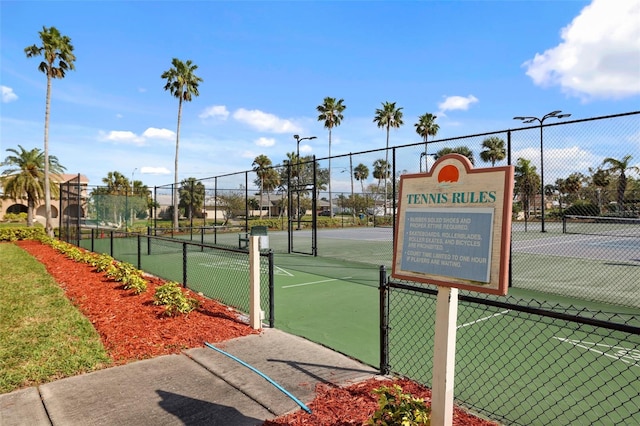 view of sport court featuring fence