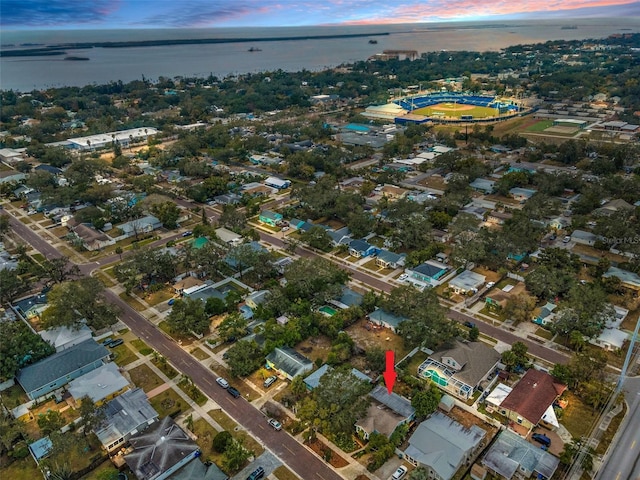 aerial view at dusk featuring a water view