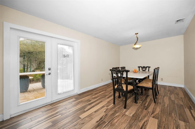 dining space featuring dark hardwood / wood-style flooring and french doors